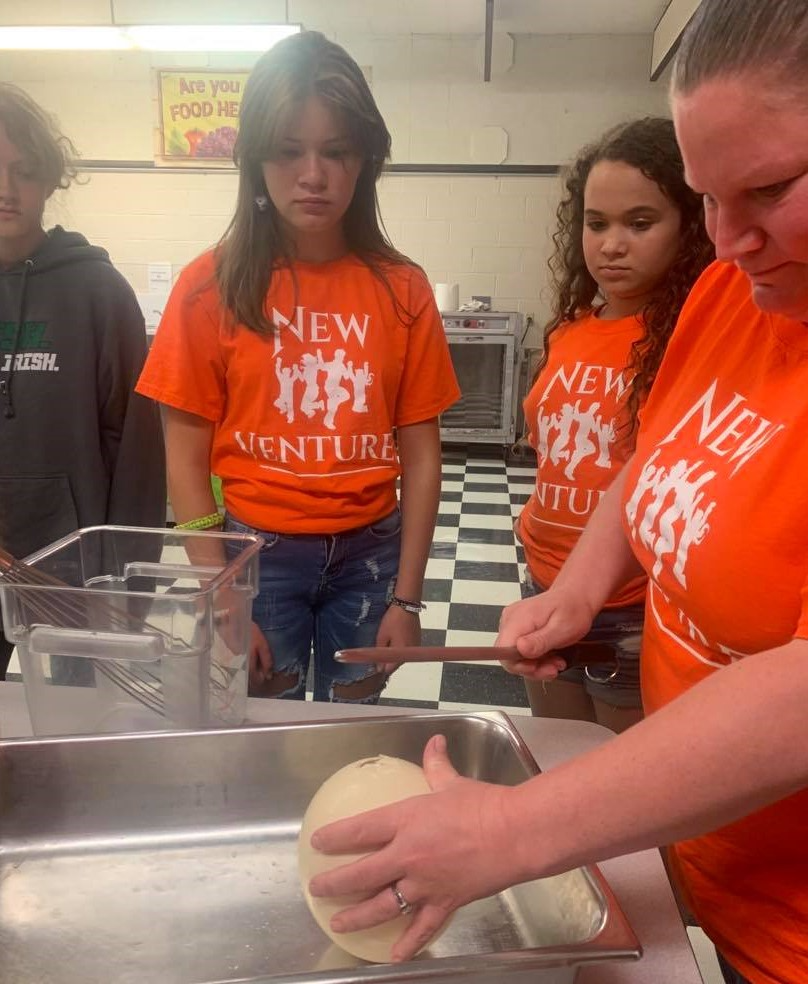 Camp counselors (and campers) learn about (and eat!) Ostridge eggs.