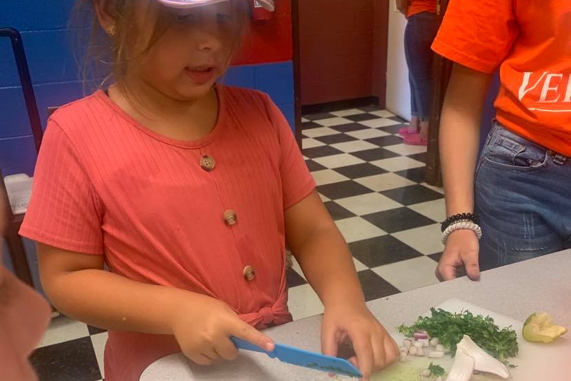 New Ventures Campers have fun in the cafeteria participating in various projects.