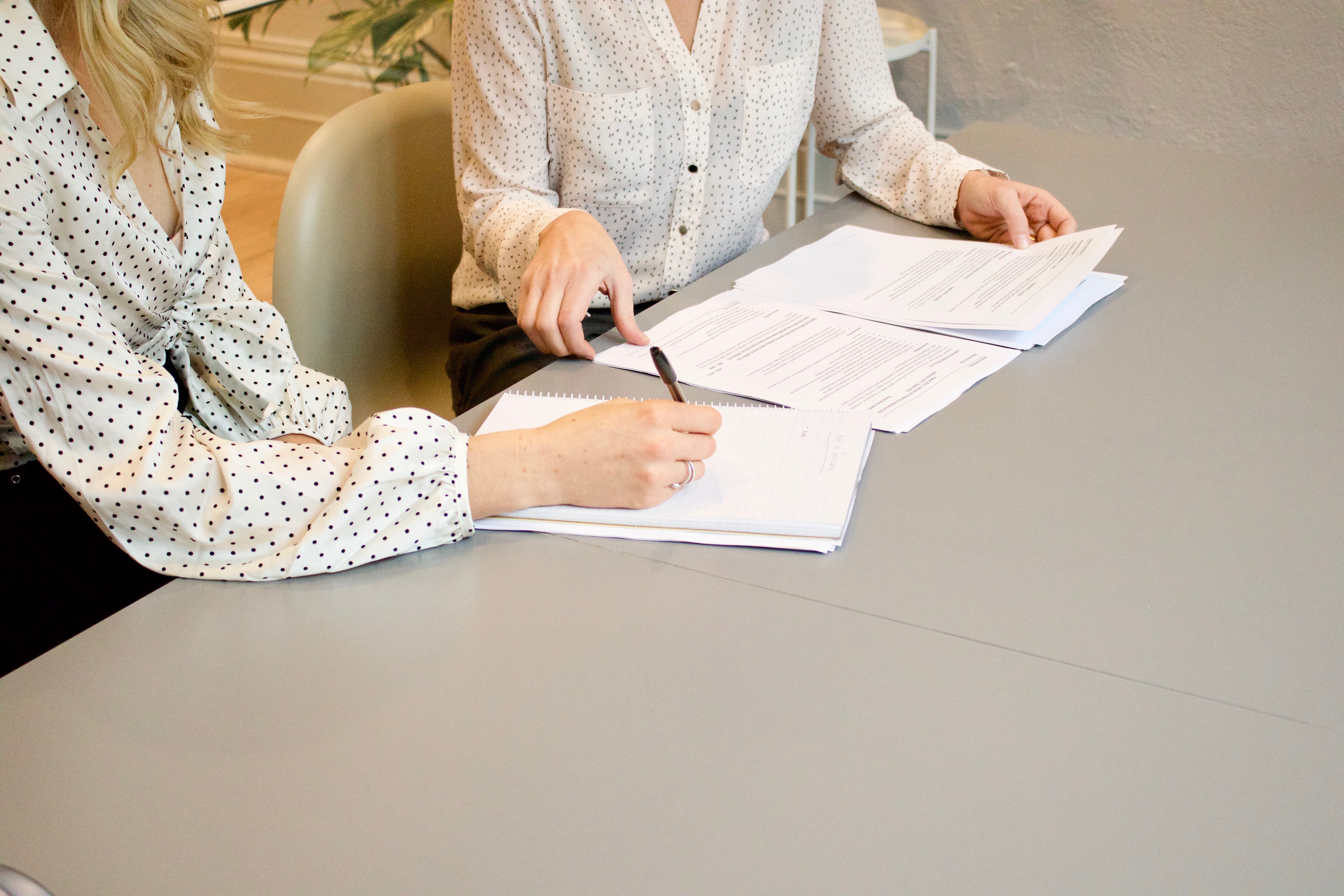 people signing documents