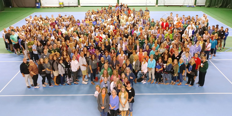 Faculty group picture standing in the formation of a maple leaf