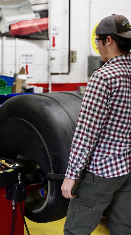Man standing next to a wheel