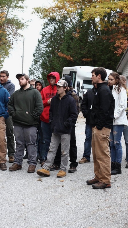 Students gathered outside looking at something out of the frame