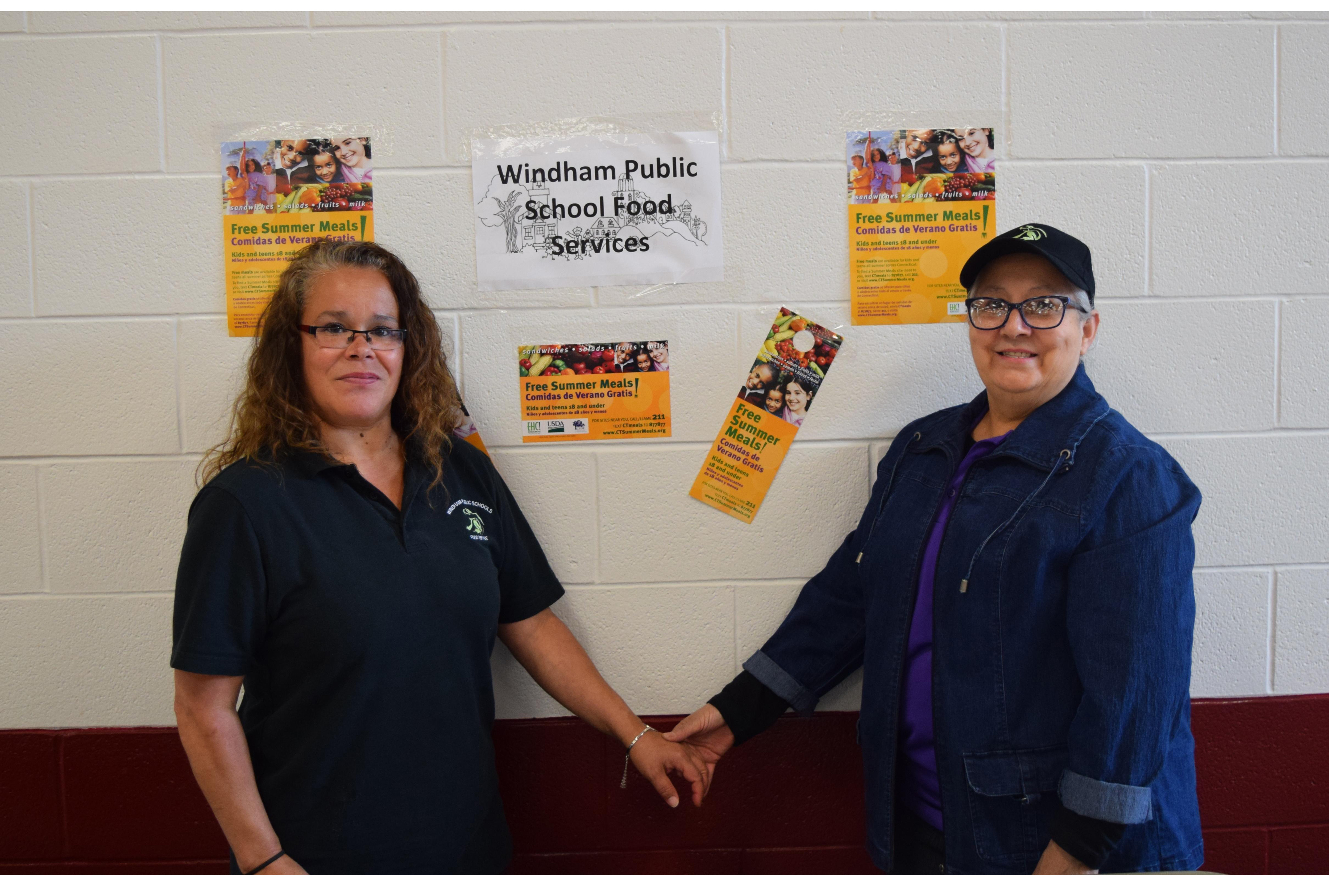 Two staff members posing for picture