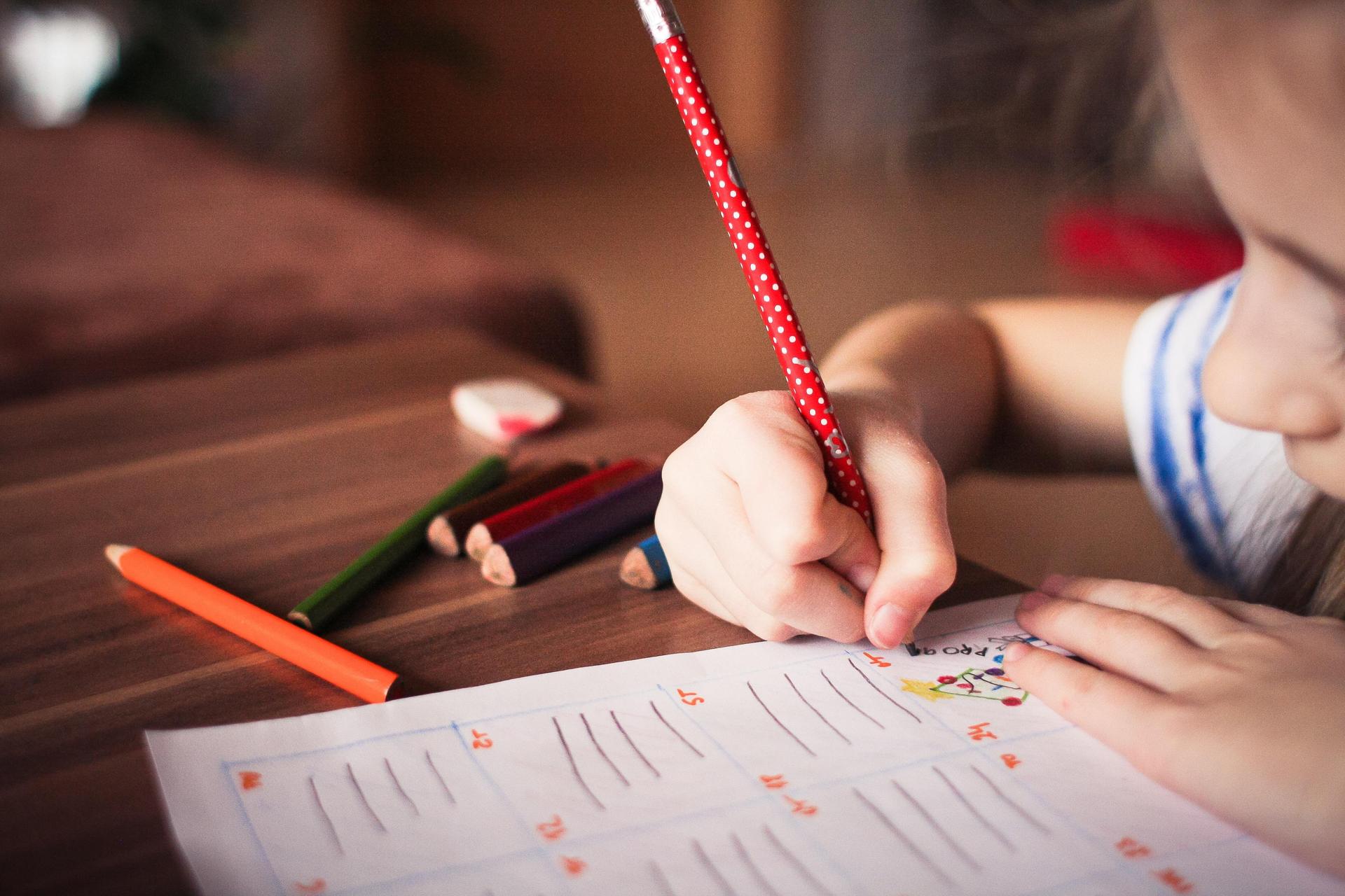 Photo of a girl writing.