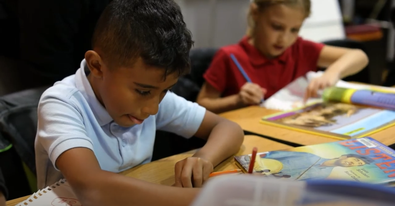 boy at desk reading