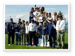 A photo of a track and field team winning an award at a meet