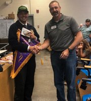 Staff member shaking hand with Student