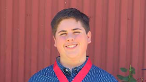 male student with an award