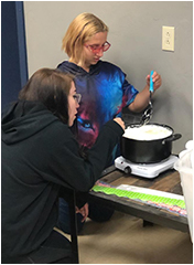 Students at table doing experiment