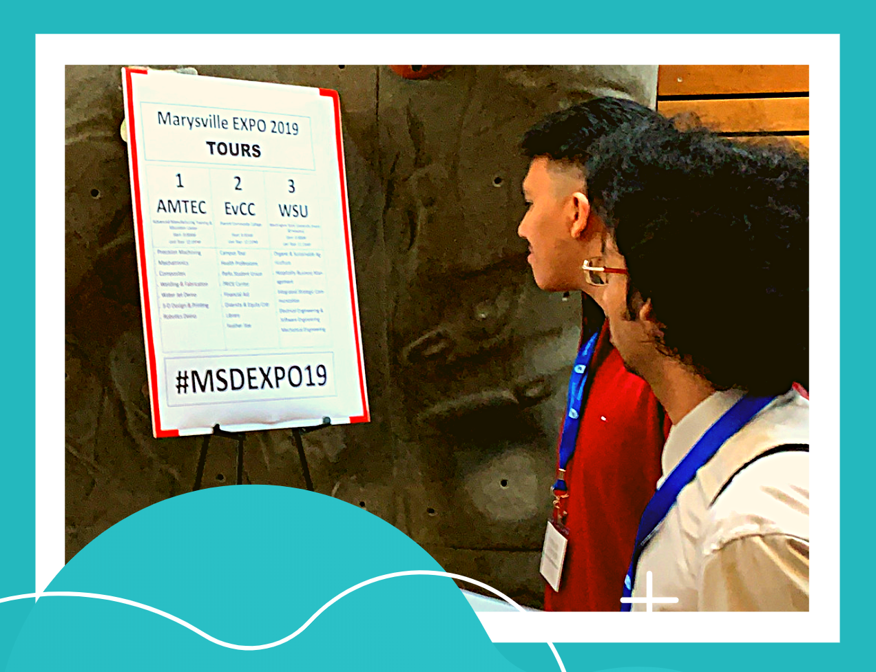 Two professor looking at the attendees for the expo