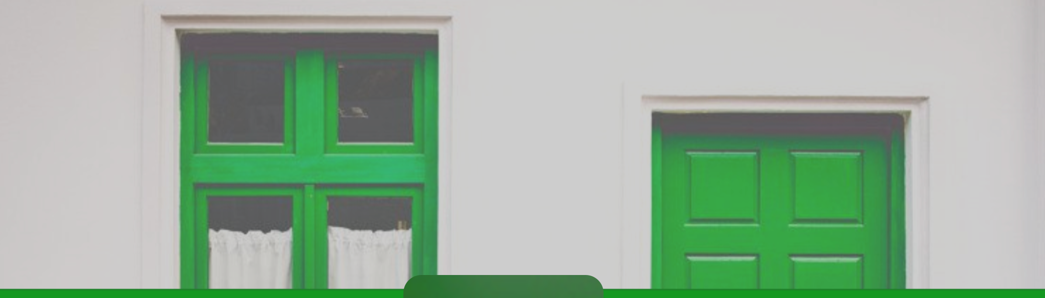 A photo of a house with green door and window
