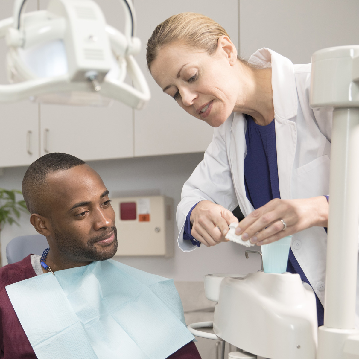 A photo of a dentist with her patient