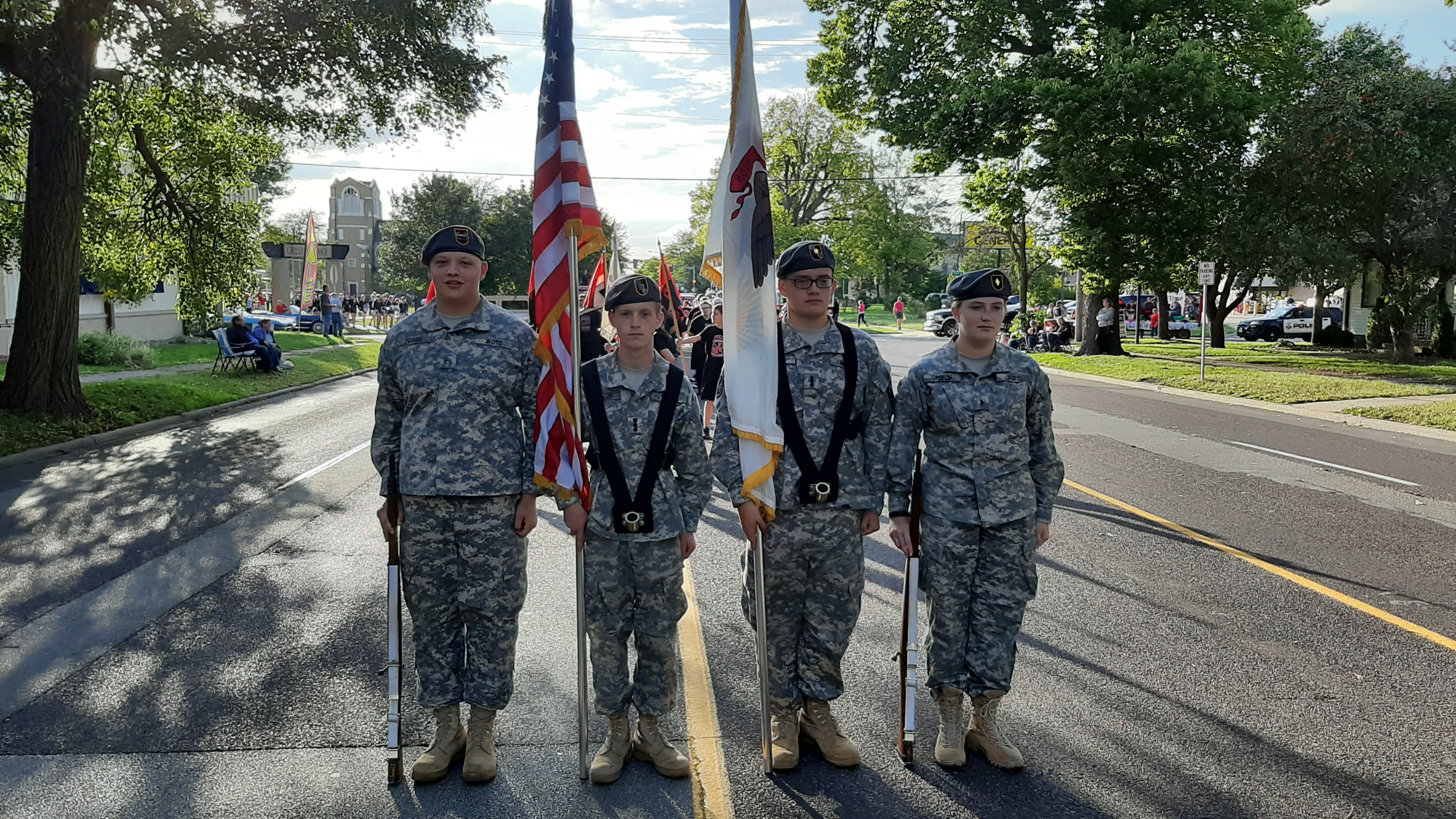 A photo of the color guard holding flags in a parade